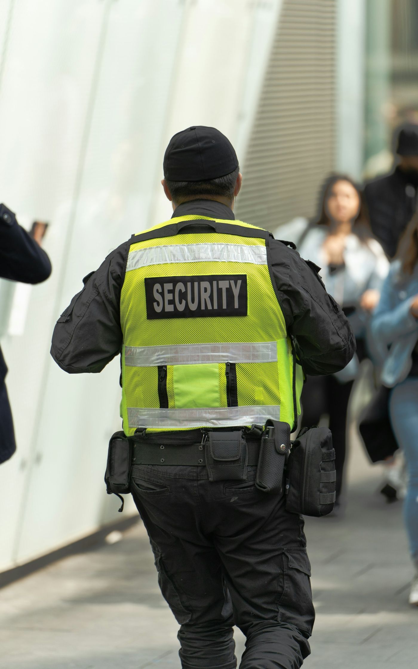 Uniformed security officer in a hi-vis SECURITY vest